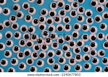 white black  googly eyes isolated on a blue background