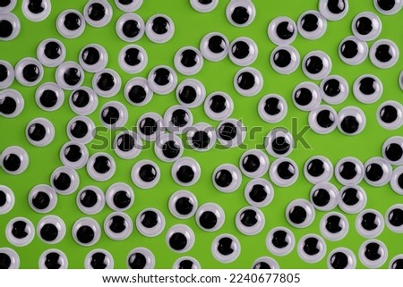 funny  googly eyes isolated on a green background