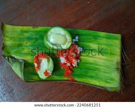 Row mango with salt and chillies Powder.raw mango with salt and chilli isolated in wooden table.Nadan pacha manga with salt and chilli stock images Pacha Manga | പച്ച മാങ്ങ | Nostalgic Kerala