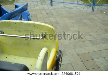 The old yellow toy car that was at the fair
