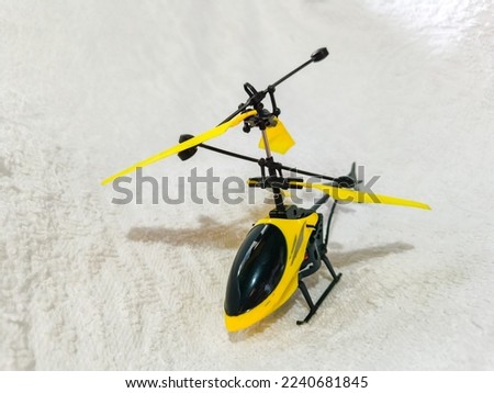 black and yellow helicopter toy on the white background