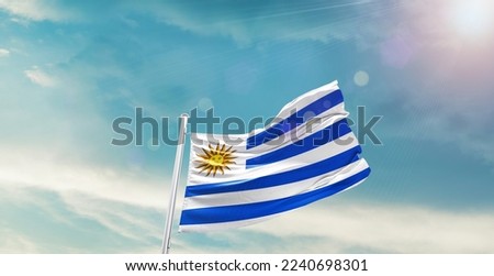 Uruguay Flag on pole for Independence day. The symbol of the state on wavy cotton fabric.