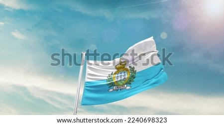 San Marino Flag on pole for Independence day. The symbol of the state on wavy cotton fabric.