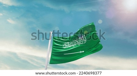 Saudi Arabia Flag on pole for Independence day. The symbol of the state on wavy cotton fabric.