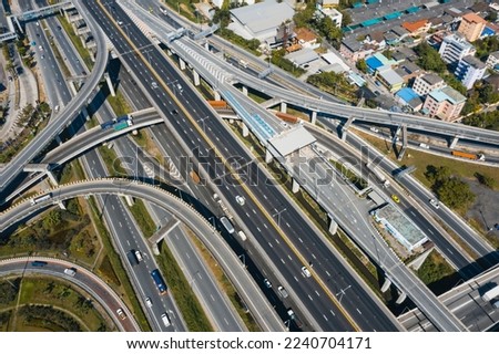 Multilevel junction motorway top view, Road traffic an important infrastructure in Thailand. Expressway Road and Roundabout. Transportation and travel concept. Royalty-Free Stock Photo #2240704171