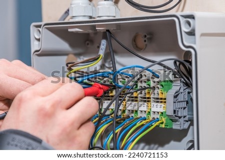 Electrical engineer working with power connection - wires, close-up Royalty-Free Stock Photo #2240721153