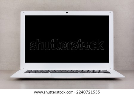 black mock up on a laptop screen on a gray background close-up front view