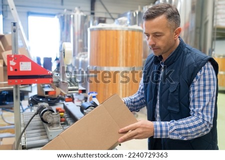 portrait of adult glad male brewery worker