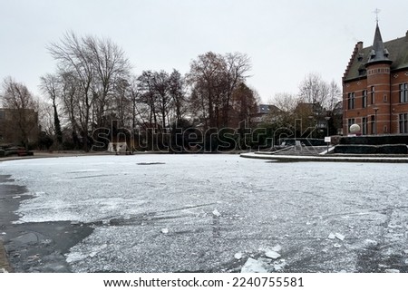 Frosted pond next to Brasserie Mariadal building in Zaventem, Belgium Royalty-Free Stock Photo #2240755581