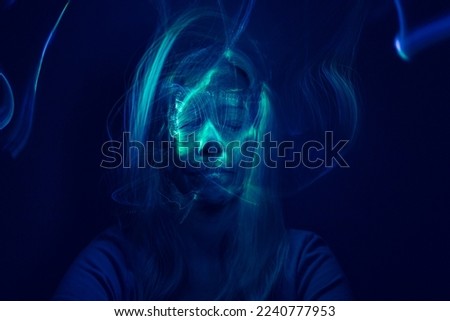 Face of a woman with online light effects. Futuristic look. Long exposition. Royalty-Free Stock Photo #2240777953