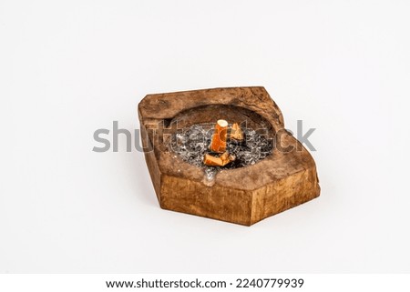 Cigarette butt in an ashtray. the white background