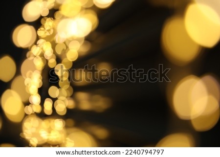Golden blurred lights on black background. Bokeh effect