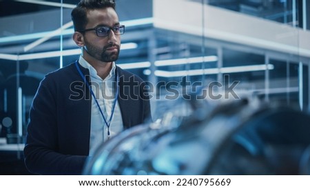 Smart Chief Engineer in Glasses Explaining the Advanced Technology of a Modern Innovative Industrial Invention to a Team of College Students on an University Course. Royalty-Free Stock Photo #2240795669