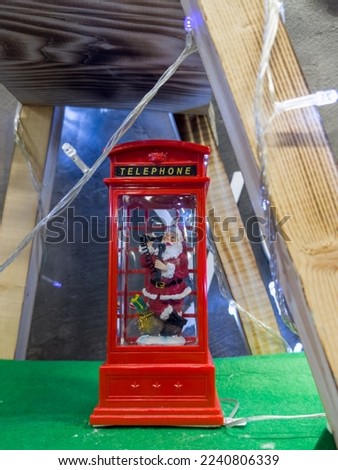 Santa Claus wishes Merry Christmas on the phone. New Year. Christmas decorations, toys, gifts. Souvenirs for the new year. Christmas decoration. Garland. Christmas symbol. Santa Claus,