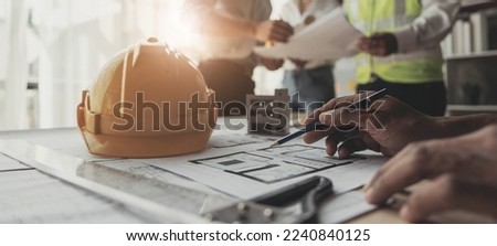 Civil engineer teams meeting working together wear worker helmets hardhat on construction site in modern city. Foreman industry project manager engineer teamwork. Asian industry professional team	

 Royalty-Free Stock Photo #2240840125