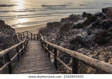 wooden staircase between cliffs leading to the beach
