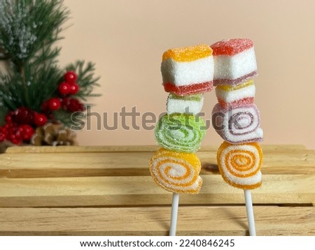 Fruit flavored gelatin and jelly with marshmallow picked skewers.