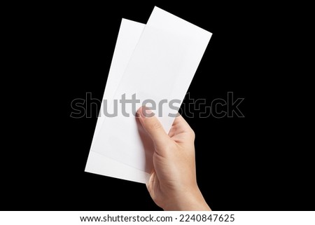 Two empty paper sheets in hand, isolated on black background Royalty-Free Stock Photo #2240847625
