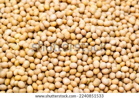Food background texture, pile of dried soybeans seeds.