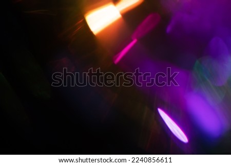 Blurred Light painting one exposure in camera. light glares with a spectral gradient on a dark background. Multicolored abstract colorful line. Unusual light effect. Royalty-Free Stock Photo #2240856611
