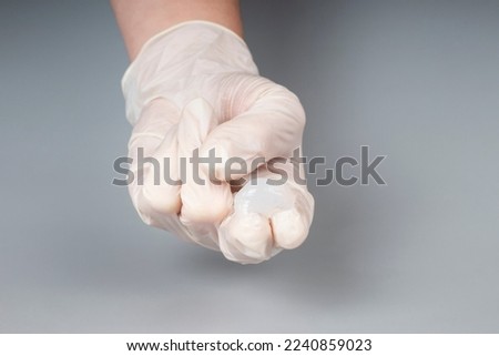urologist appointment concept, lubricant on the fingers of a doctor in gloves,massage prostate.