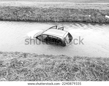 Grey car falls and drowning in the river.