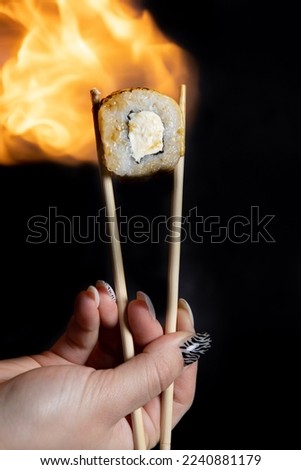 Susi with chopsticks on a plate 