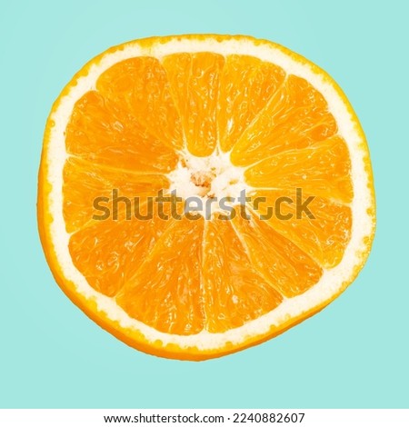 A slice of orange isolated on blue background.