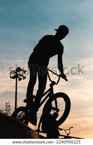 Silhouette of acrobat cyclist on track