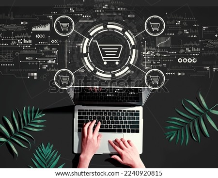 Online shopping theme with person using a laptop computer