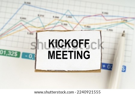 Business concept. Against the background of business graphics and pens, a sign with the inscription - Kickoff Meeting Royalty-Free Stock Photo #2240921555