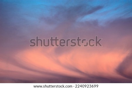 Background image of a colorful and dramatic cloudy sky at the dawn of a polar day in the Arctic. an interesting configuration of clouds. Blank for replacing the sky in photo images