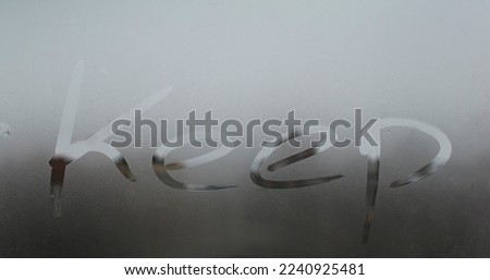 The written word on the fogged glass