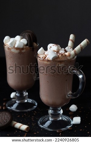chocolate ice cream.coffee with marshmallows and wafer stick. Delicious Hot Viennese Coffee In Glass Cup With Whipped Cream.Winter and autumn time. Christmas drink on the black background. copy space.
