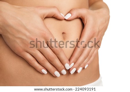 Pregnancy or diet concept, female hands forming heart shape on the stomach isolated on white background Royalty-Free Stock Photo #224093191