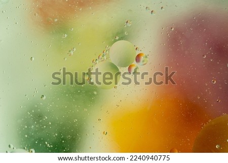 Abstract gradient blurred background in green yellow and orange colors. Geometric shapes balls of different sizes. Cosmetic background for the presentation of cosmetics. macro photo, selective focus 