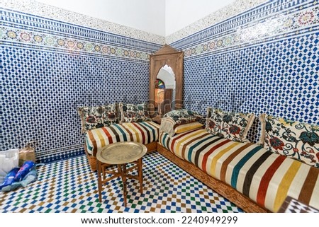Beautiful traditional Moroccan salon with colorful mosaic tiles inside an old guest house in Morocco Royalty-Free Stock Photo #2240949299