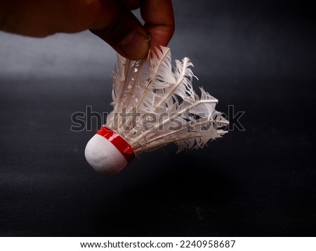 Picture of a broken shuttlecock on a black isolated background