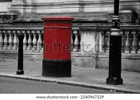 Red mailbox on the London street.