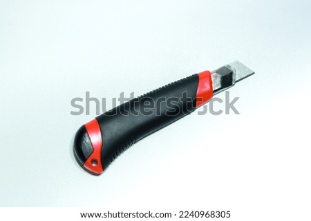 black and red knife cutter on a white background