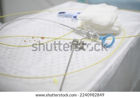 In the operating room, there is an instrument for cystoscopy and stones from the bladder and urethra on the table. The veterinarian spent a pet with urolithiasis extracting stones using an endoscope. Royalty-Free Stock Photo #2240982849