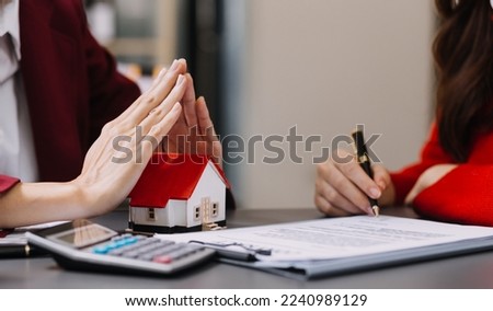 Discussion with a real estate agent, House model with agent and customer discussing for the contract to buy, get insurance or loan real estate or property.