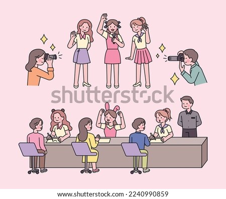 A girl idol is holding a fan meeting event. Fans take pictures of idols. They are having a conversation at the table. Royalty-Free Stock Photo #2240990859