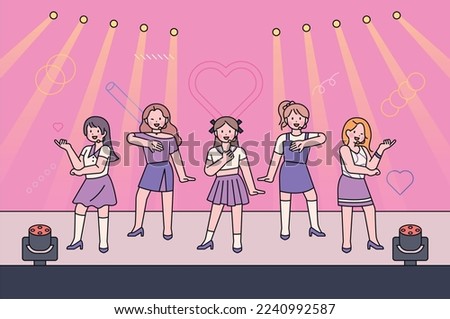 A girl group idol is performing on a fancy stage. They are dancing and singing on stage. Royalty-Free Stock Photo #2240992587