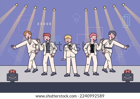 A boy group idol is performing on a fancy stage. They are dancing and singing on stage. Royalty-Free Stock Photo #2240992589