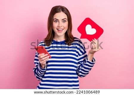 Photo of cheerful adorable lady wear trendy clothes use modern device write facebook instagram post isolated on pink color background