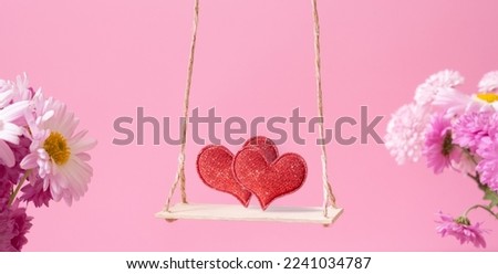 A swing with two hearts on pink background. Creative banner for Happy Valentines Day.