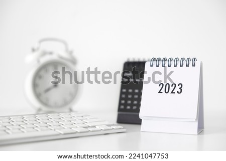 2023 business calendar, keyboard and clock on office table in new year day. Make a work plan for the start of the year. Concept about Celebration, Business, Christmas, New Year.
