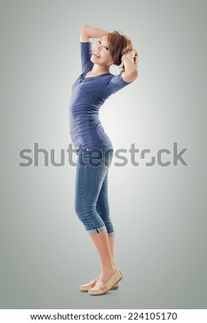 Excited Asian young girl, full length portrait isolated.