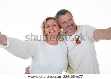 senior elderly woman man couple makes cell selfie photo with mobile phone on white background